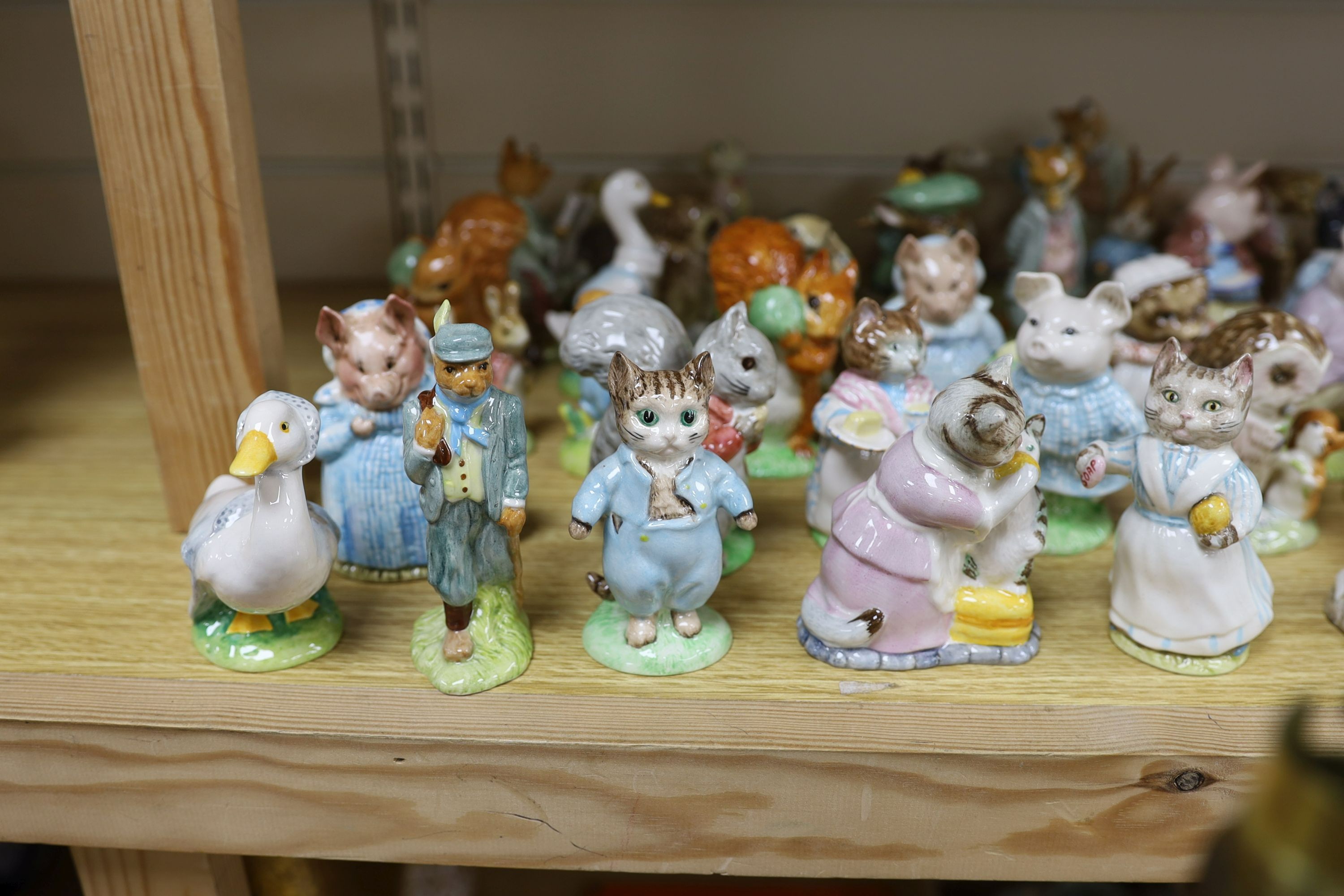 A large collection of Beatrix Potter ceramic figures by Royal Doulton, Beswick and Royal Albert, to include ‘Sir Isaac Newton’ and ‘Mr McGregor’